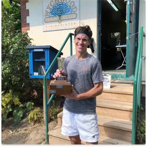 Mark Evans Holding a Trophy